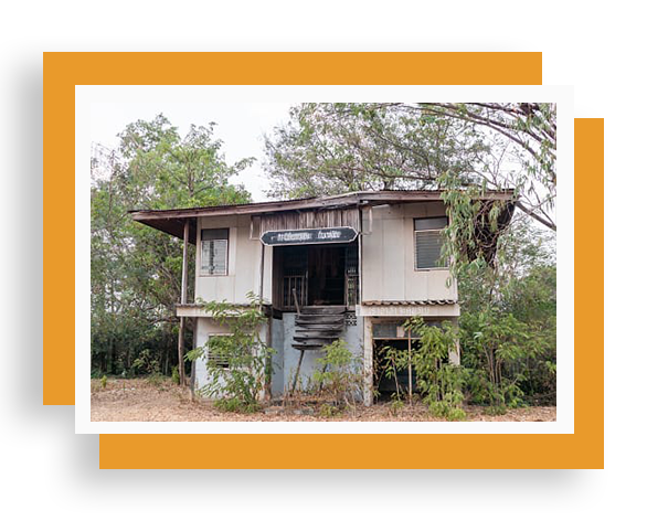 A house with trees in the background and a yellow frame