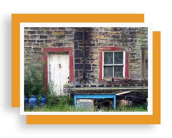 A picture of an old building with red trim.